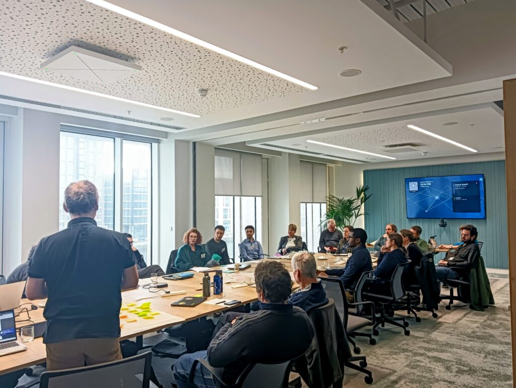 People seated around a boardroom table in an office.